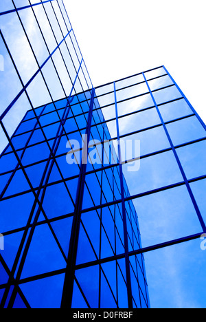 Office building details reflecting blue sky and clouds in windows Stock Photo