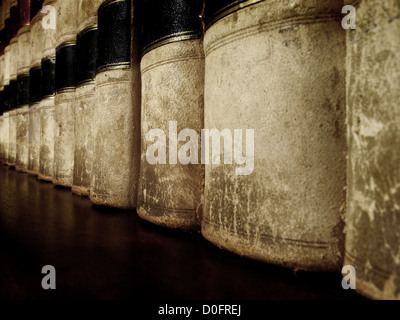 Row of old worn leather law books on shelf Stock Photo