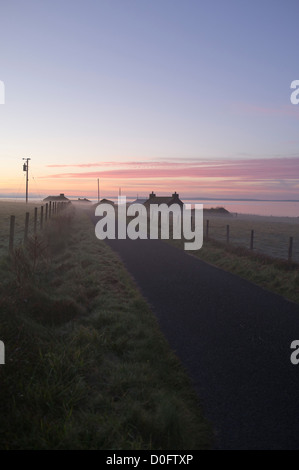 dh  ORPHIR ORKNEY Cottages in mist morning sunrise over Scapa Flow dew uk sun rise Stock Photo