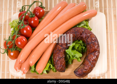 Smoked frankfurters and sausage ring with tomato Stock Photo