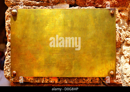 Blank copper signboard close-up over stone wall Stock Photo