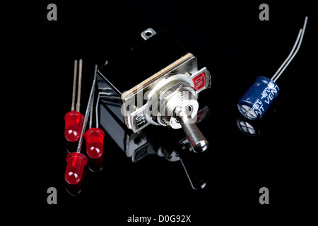 Close up of a switch with on and off labeled with LEDs and capacitors Electrical PCB component Stock Photo