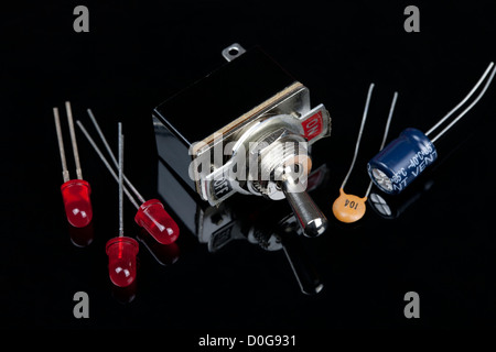 Close up of a switch with on and off labeled with LEDs and capacitors Electrical PCB component Stock Photo