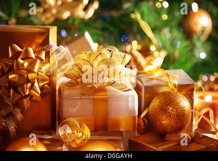 Image of luxury New Year gifts, different present boxes under Christmas tree in holiday eve, Christmastime celebration Stock Photo