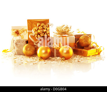 Image of golden gift boxes isolated on white background, variety of presents decorated with Christmas tree toys, studio shot Stock Photo
