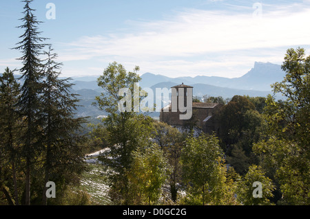 A view from the tiny hilltop village of Gigors of the Romanesque St Peter’s Church and the mountainous landscape of the Vercors. La Drôme, France. Stock Photo