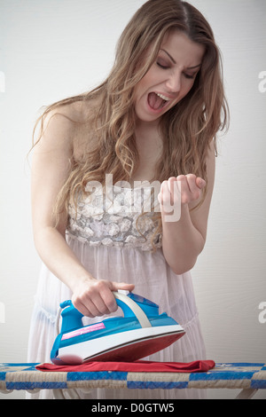 woman ironing and burning the hand Stock Photo