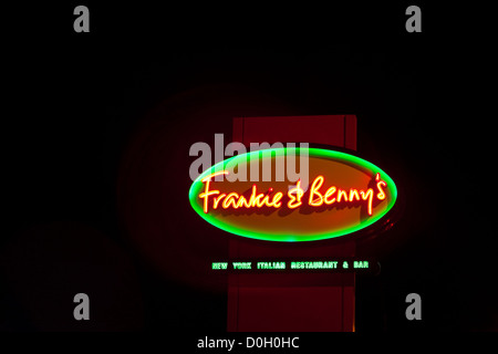 Shop sign, Frankie and Benny's, New York Italian Restaurant and Bar, after dark, Kent, UK Stock Photo