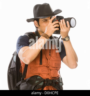 Young male photographer photographing with a digital camera Stock Photo