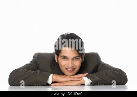 Portrait of a businessman resting his chin on his hands Stock Photo
