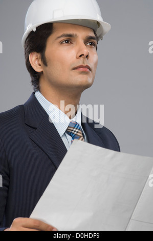 Close-up of a young male architect holding a paper Stock Photo