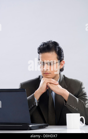 Businessman looking at a laptop Stock Photo