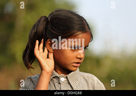 Indian girl cupping her ear to improve hearing Andhra Pradesh South India Stock Photo