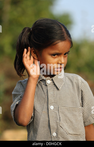 Indian girl cupping her ear to improve hearing Andhra Pradesh South India Stock Photo