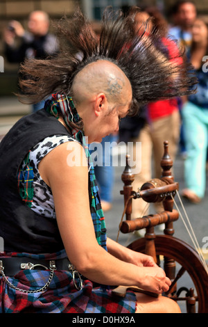 Woman with Mohican hairstyle spinning yarn, Edinburgh, Scotland Stock Photo