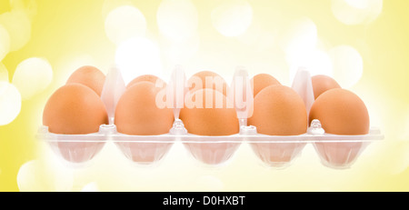 pack of eggs with yellow lights in the background Stock Photo