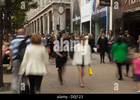 A view down Oxford Street with shoppers moving along the path. Stock Photo