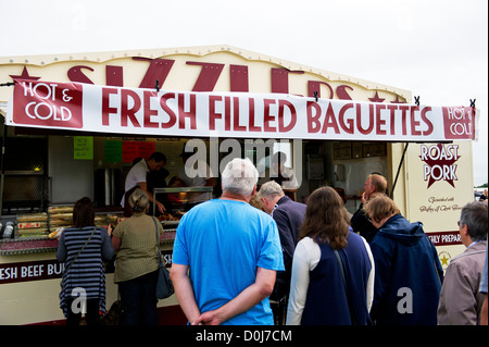 Customers queuing at a fast food stall. Stock Photo