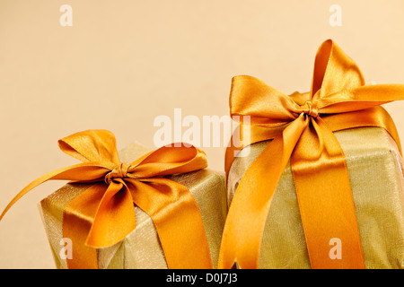 Two gift boxes wrapped in gold ribbons with copy space Stock Photo