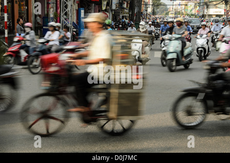 HO CHI MINH CITY, Vietnam - A man on a bicycle negotiates the heavy traffic of downtown Ho Chi Minh City, Vietnam. Stock Photo