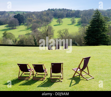 Deckchairs and trees in the grounds of Polesden Lacey Gardens in Surrey. Stock Photo