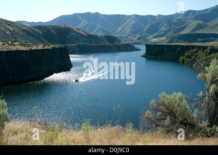 A boat pulls a water skier on Lucky Peak Reservoir in Idaho, USA. Stock Photo