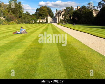 Students sat on the grass at Trinity College in Oxford. Stock Photo