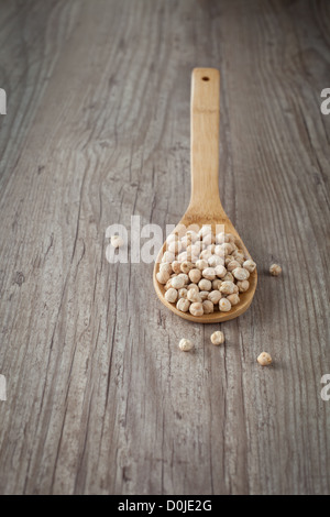 Bunch of raw chickpeas on a wooden spoon Stock Photo