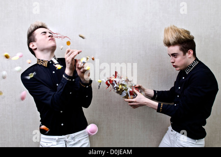 John Grimes and Edward Grimes from Jedward throwing sweets Stock Photo