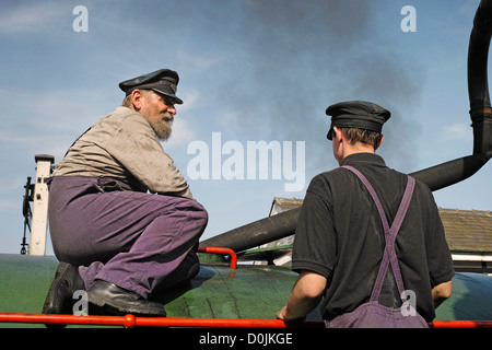 Happy engineer and assistant on a steam train belonging to the Colne Valley Railway. Stock Photo