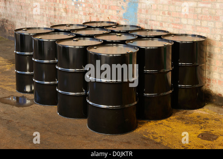 Twelve black oil drums Stock Photo