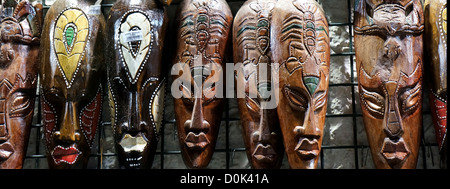 Wooden african masks hanging in a bazaar of Tunisia Stock Photo