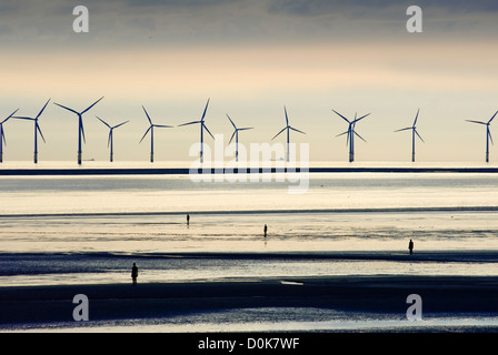 Sculptures and wind turbines on a Liverpool beach. Stock Photo