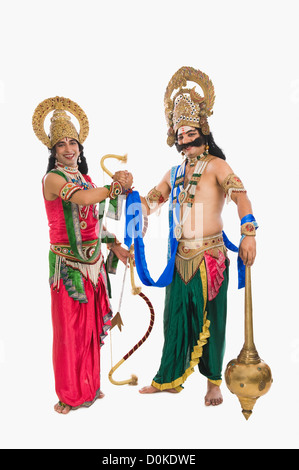 Two stage artists dressed-up as Rama and Ravana and shaking hands Stock Photo