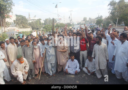 Drivers who privately owned transports blocked the rod as  they are protesting against unofficial strike call by the CNG Pumps owners during a  demonstration at M.A Jinnah Road in Karachi on Tuesday, November 27, 2012. The rickshaw  and taxi drivers, irked by the unannounced CNG closure, blocked the MA Jinnah Road by  bringing their vehicles to halt. Due to their protest, a massive traffic jam was observed on MA  Jinnah and the other adjoining roads. Stock Photo