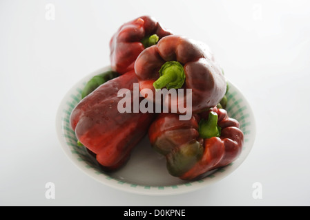 Red and green peppers on white background Stock Photo