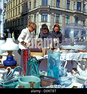 Young women shopping at an antiques stall in an outdoor Copenhagen street market  Denmark   KATHY DEWITT Stock Photo