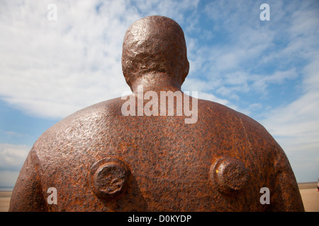 One of the cast iron figures on Crosby Beach that make up the Anthony Gormley Another Place installation. Stock Photo