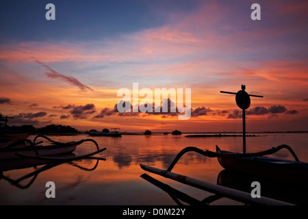 sunset over traditional fishing boats on Bali, Indonesia Stock Photo