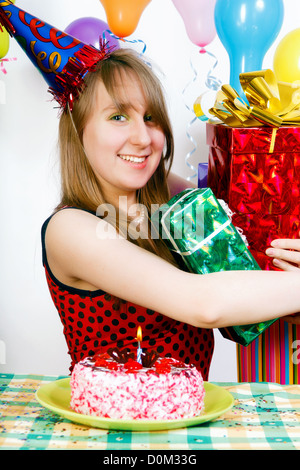 Birthday girl. A teenager with a bunch of gift boxes Stock Photo