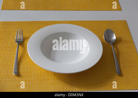 Empty plate on dinner table Stock Photo