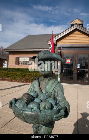 A statue of Johnny Appleseed welcomes visitors to the Massachusetts Visitor Center in Lancaster, Massachusetts. Stock Photo