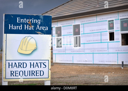 Construction Hard Hat Sign to be careful in work area building new homes Stock Photo