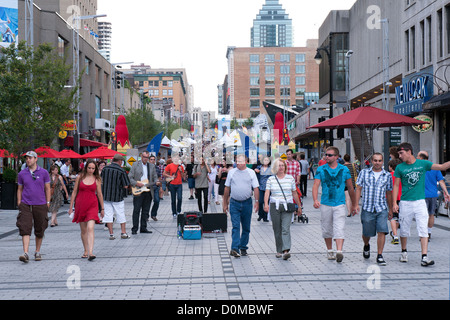 Pedestrians on a part Ste Catherine street which is closed to ...