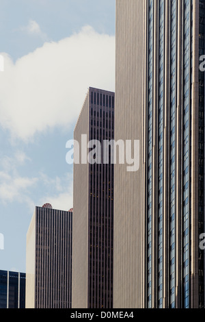 The low-angle view of modern skyscrapers under the blue sky with clouds ...