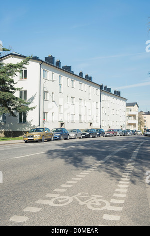 Cars parked in front of block of flats Stock Photo