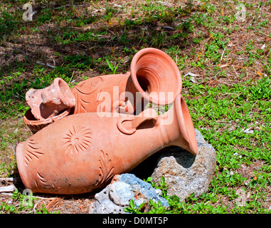 Greek amphoras lying on green grass Stock Photo