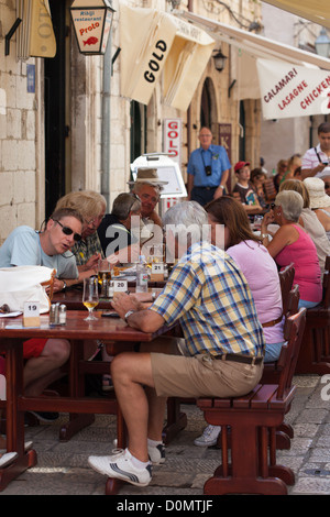 friends eating outdoors. cafes and customers in the side streets in Dubrovnik Croatia Stock Photo