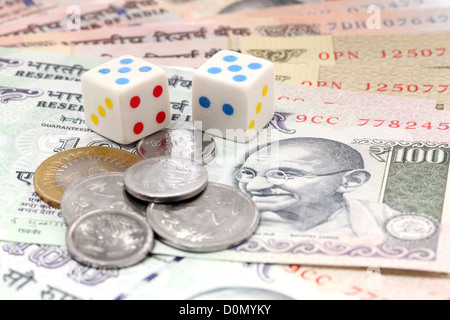 Dices and rupee coins on Indian rupee notes Stock Photo