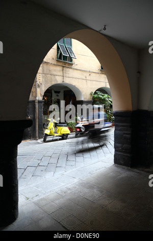 Moped passing by in Chiavari in Liguria, Italy Stock Photo